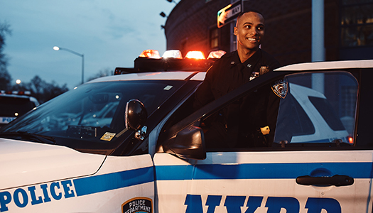 A New York Police Department getting into his squad car