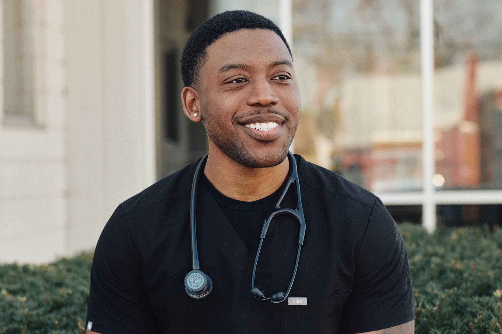 A health care professional with a stethoscope around his neck