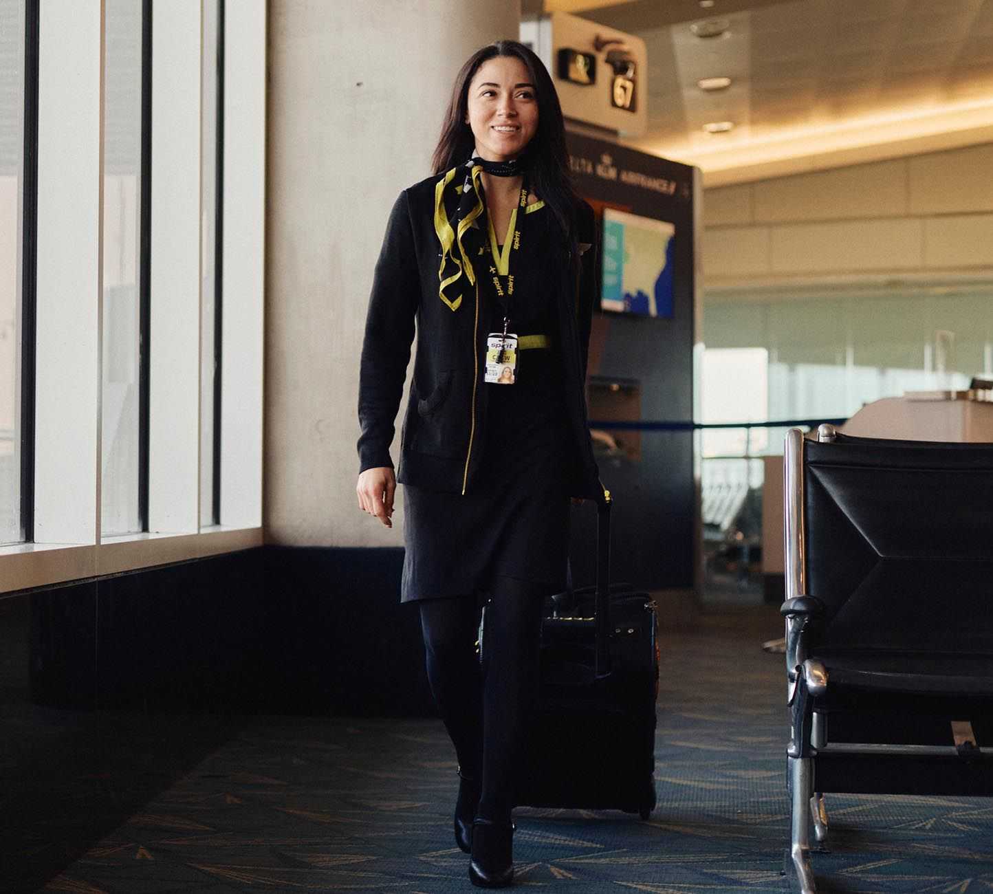 Woman with a suitcase walking through an airport